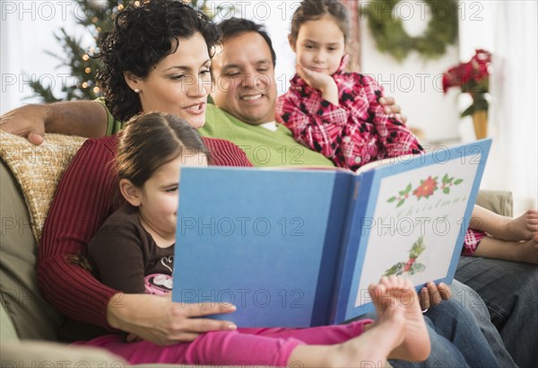 Family reading together on sofa