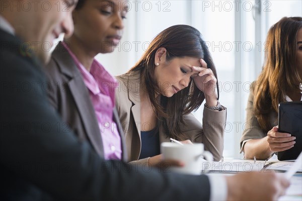 Businesswoman making notes in meeting