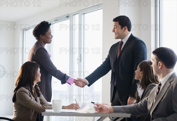 Business people shaking hands in meeting