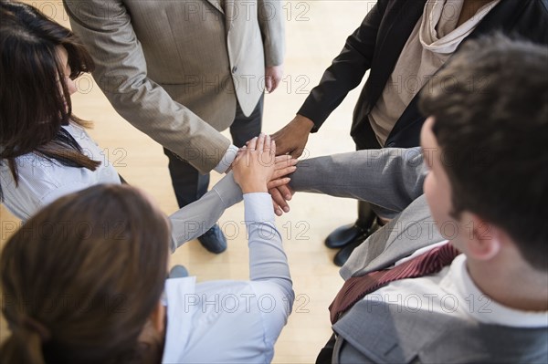 Business people putting hands in circle