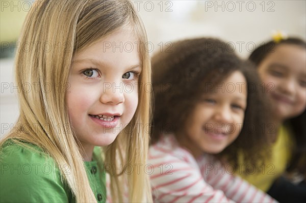 Smiling girls sitting in line