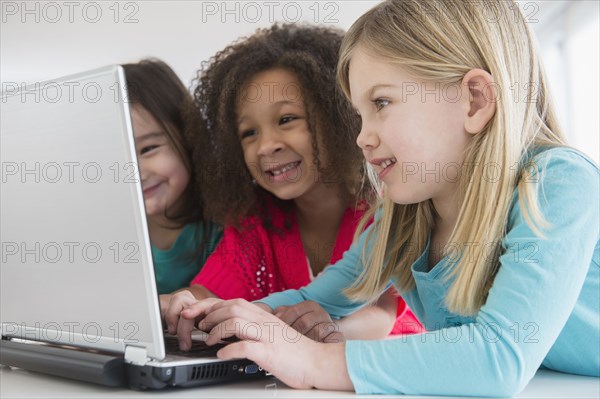 Girls using laptop together