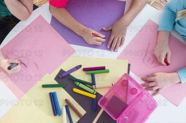 Girls coloring at desk