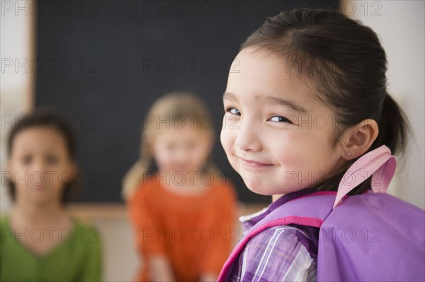 Smiling girl looking over her shoulder