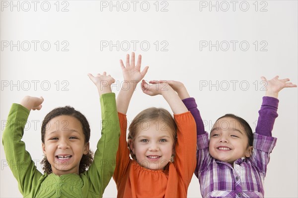 Smiling girls cheering together