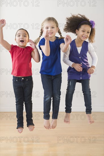 Girls jumping for joy together