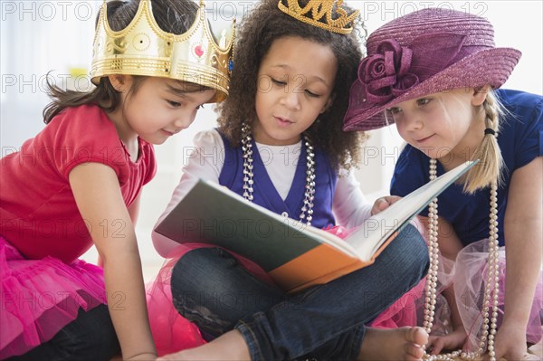 Girls reading book together