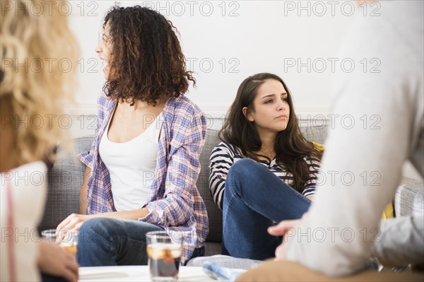 Friends relaxing in living room