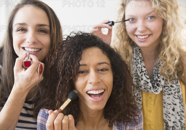 Women applying makeup together