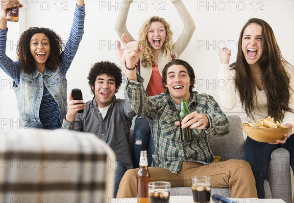 Friends cheering in living room