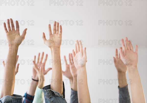 People's hands raised in air