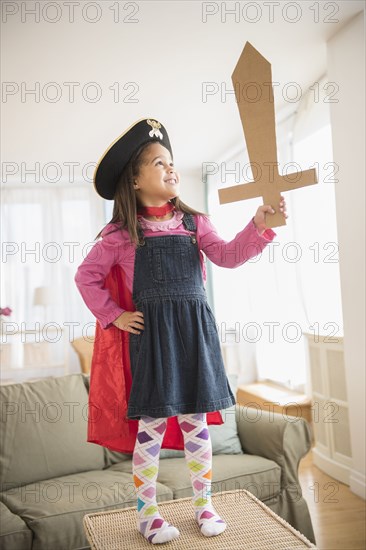 Hispanic girl playing with ape and sword