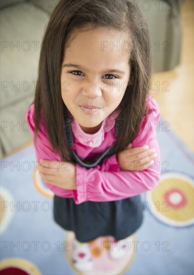 Hispanic girl pouting in living room