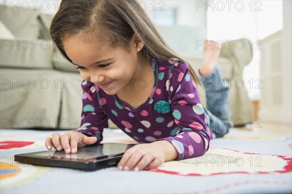Hispanic girl using tablet computer