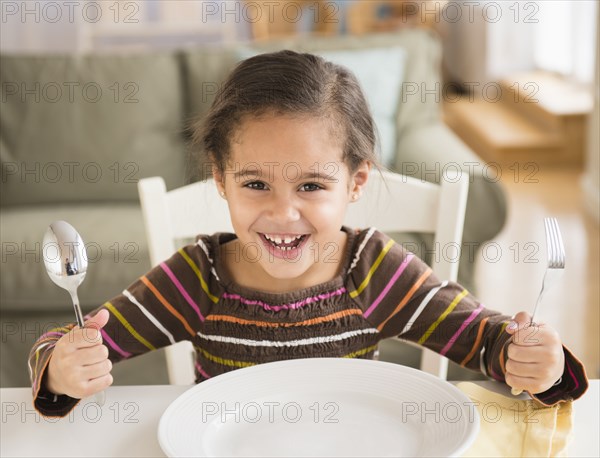 Hispanic girl demanding food at table