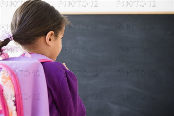 Hispanic girl wearing backpack