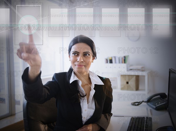 Indian businesswoman using touchscreen