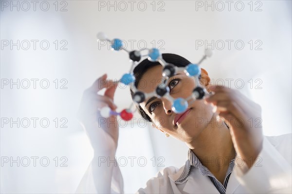 Indian scientist examining molecular model in lab