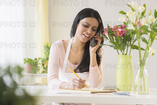 Indian florist talking on telephone