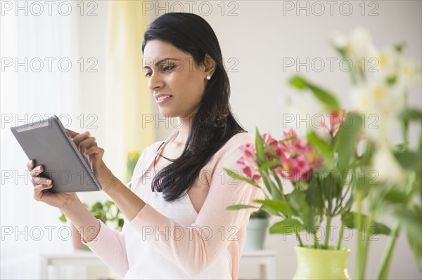 Indian florist using tablet computer