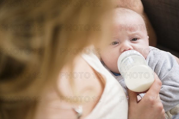 Caucasian mother feeding baby