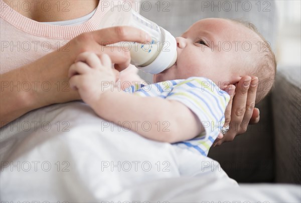 Caucasian mother bottle feeding baby