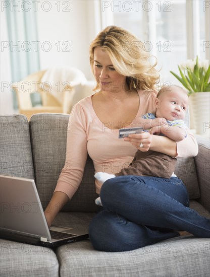 Caucasian mother with baby shopping online