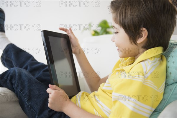 Hispanic boy using tablet computer