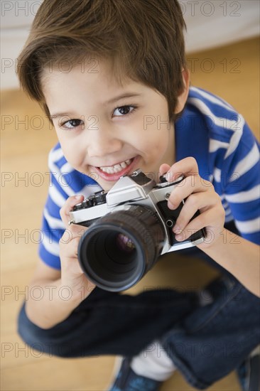 Hispanic boy taking pictures