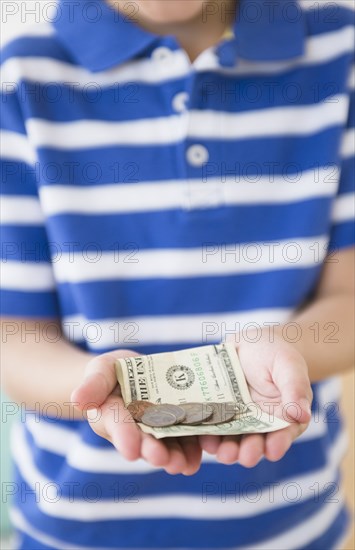 Hispanic boy holding money