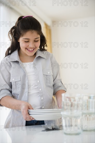 Hispanic girl setting table