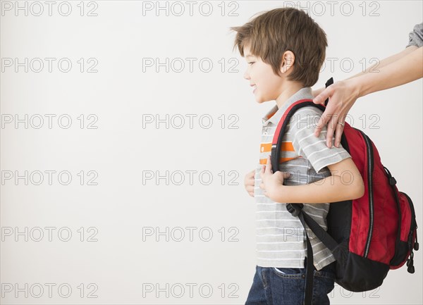 Hispanic mother rushing son to school