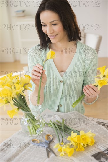 Caucasian woman arranging flowers