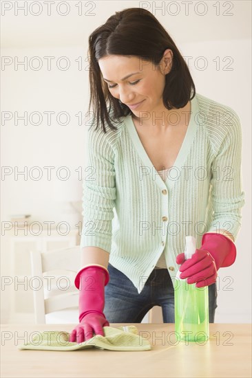 Caucasian woman cleaning desk