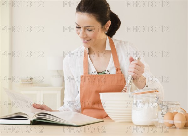 Caucasian woman baking in kitchen