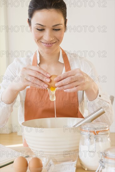 Caucasian woman baking in kitchen