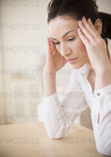 Caucasian woman rubbing her temples