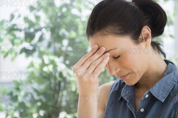 Caucasian woman rubbing her forehead