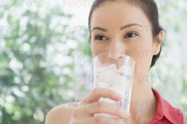 Caucasian woman drinking glass of water