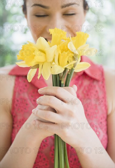 Caucasian woman smelling flowers