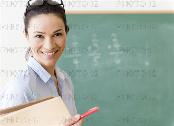 Caucasian teacher smiling in classroom