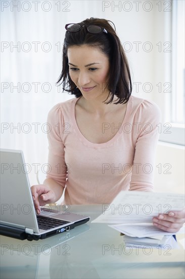 Caucasian woman paying bills online