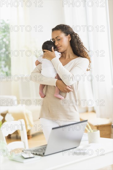 Hispanic mother holding infant son