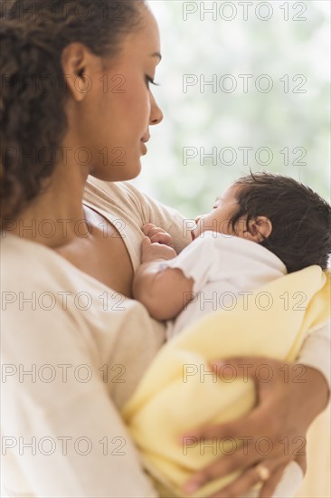 Hispanic mother holding infant son