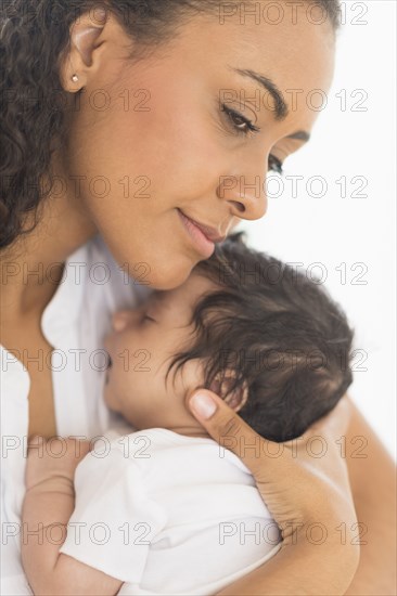 Hispanic mother holding infant son