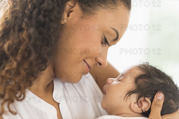 Hispanic mother holding infant son