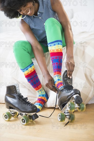 Mixed race woman putting on roller skates