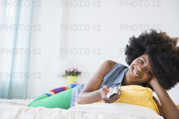 Mixed race woman watching television