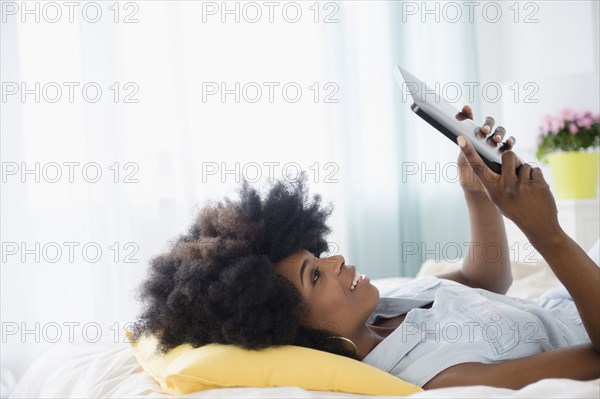 Mixed race woman using digital tablet