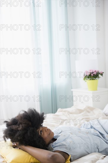 Mixed race woman laying on bed